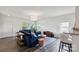 Bright living room with hardwood floors, large windows, a blue sofa and stylish decor at 1218 Juddson Dr, Waxhaw, NC 28173