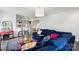 Inviting living room featuring a comfortable sofa, stylish decor, and a view into the kitchen at 1218 Juddson Dr, Waxhaw, NC 28173