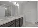Bathroom with dual vanity sinks, quartz countertops, and a tiled walk-in shower at 124 Canary Ln # 7, Mooresville, NC 28115