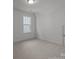 Neutral bedroom with carpet flooring, natural light, and a closet, offering a comfortable and versatile space at 124 Canary Ln # 7, Mooresville, NC 28115