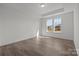 Bright bedroom with wood floors and a large window offering abundant natural light and outdoor views at 124 Canary Ln # 7, Mooresville, NC 28115