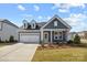 Charming home with a two-car garage, neat landscaping, and a welcoming entrance for an inviting curb appeal at 124 Canary Ln # 7, Mooresville, NC 28115