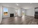Bright living room features wood floors, a fireplace, and windows offering views of the outdoors at 124 Canary Ln # 7, Mooresville, NC 28115