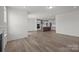 Open-concept living space features wood floors and a fireplace, seamlessly connected to the modern kitchen at 124 Canary Ln # 7, Mooresville, NC 28115