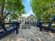 Backyard featuring a fire pit surrounded by Adirondack chairs and a screened-in porch on the house at 13316 Alex Mill Dr, Pineville, NC 28134