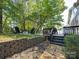 Spacious backyard with a fire pit, deck, and lush greenery at 13316 Alex Mill Dr, Pineville, NC 28134