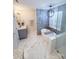 Beautiful bathroom with marble floors, soaking tub, glass shower, and modern fixtures at 13316 Alex Mill Dr, Pineville, NC 28134