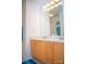 Bathroom featuring a double sink vanity with oak cabinets and a large mirror at 13316 Alex Mill Dr, Pineville, NC 28134