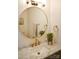 Bathroom featuring a round mirror, marble countertop, and gold fixtures at 13316 Alex Mill Dr, Pineville, NC 28134
