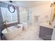 Relaxing bathroom with soaking tub, glass shower, and modern fixtures at 13316 Alex Mill Dr, Pineville, NC 28134