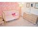 Adorable Bedroom with crib, changing table, and decorative wallpaper at 13316 Alex Mill Dr, Pineville, NC 28134