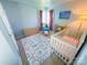 Bright Bedroom with a white crib, dresser, and bay window with pink curtains at 13316 Alex Mill Dr, Pineville, NC 28134