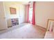 Bright bedroom with neutral carpet, pink curtains, and a view of the outdoors at 13316 Alex Mill Dr, Pineville, NC 28134