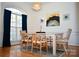Bright dining room with a chandelier, hardwood floors, and lots of natural light at 13316 Alex Mill Dr, Pineville, NC 28134