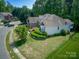 Exterior view of a well-maintained home showing the backyard and landscaping at 13316 Alex Mill Dr, Pineville, NC 28134