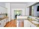 Bright kitchen with granite countertops, stainless steel appliances, and hardwood floors at 13316 Alex Mill Dr, Pineville, NC 28134