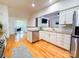 Bright kitchen with stainless steel appliances, granite countertops, and an opening to the living room at 13316 Alex Mill Dr, Pineville, NC 28134