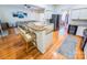 Modern kitchen with hardwood floors, white cabinetry, and a stylish breakfast bar at 13316 Alex Mill Dr, Pineville, NC 28134