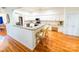 Open concept kitchen with white cabinets, granite countertops, and hardwood flooring at 13316 Alex Mill Dr, Pineville, NC 28134