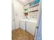 Functional laundry room with washer, dryer, and ample shelving for storage at 13316 Alex Mill Dr, Pineville, NC 28134