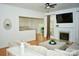 Cozy living area with hardwood flooring, a marble fireplace, and a view into the kitchen at 13316 Alex Mill Dr, Pineville, NC 28134