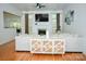 Bright living room featuring hardwood floors, a fireplace, and a stylish console table at 13316 Alex Mill Dr, Pineville, NC 28134