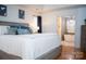 Comfortable main bedroom suite with hardwood floors and open access to ensuite bath with soaking tub at 13316 Alex Mill Dr, Pineville, NC 28134