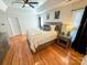 Well-lit main bedroom with hardwood floors, ceiling fan, and tasteful decor at 13316 Alex Mill Dr, Pineville, NC 28134