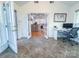 Sunroom featuring a desk and a doorway to the kitchen at 13316 Alex Mill Dr, Pineville, NC 28134