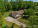 Desirable home featuring an attached garage, long driveway, and a welcoming front porch nestled in trees at 1374 Weatherby Dr, Salisbury, NC 28146