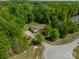 Stunning aerial view of home with lush landscaping, circular driveway, and nestled within a canopy of trees at 1374 Weatherby Dr, Salisbury, NC 28146