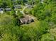 Aerial view of a secluded home with lush green landscaping, a wooded setting and a long driveway at 1374 Weatherby Dr, Salisbury, NC 28146