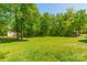 Large, grassy backyard surrounded by mature trees, offering privacy and space at 1374 Weatherby Dr, Salisbury, NC 28146