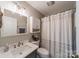 Bathroom featuring a vanity with a gray cabinet and a shower with a white and gray patterned shower curtain at 1374 Weatherby Dr, Salisbury, NC 28146