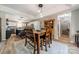 Bright dining area featuring wood flooring, a table with seating, and a view of the modern kitchen at 1374 Weatherby Dr, Salisbury, NC 28146