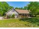 Inviting home with a charming front porch, well-manicured lawn, and mature landscaping at 1374 Weatherby Dr, Salisbury, NC 28146