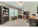Well-lit home office featuring a ceiling fan, large window, bookshelf, and a desk with a black office chair at 1374 Weatherby Dr, Salisbury, NC 28146