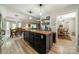 Kitchen island with wooden countertop and dark cabinetry, connecting to the dining and living areas at 1374 Weatherby Dr, Salisbury, NC 28146