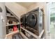 Functional laundry room with modern washer and dryer, built-in shelves, and stylish decor at 1374 Weatherby Dr, Salisbury, NC 28146