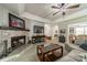 Inviting living room with a stone fireplace, a ceiling fan, and views into the dining area at 1374 Weatherby Dr, Salisbury, NC 28146