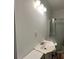 Cozy bathroom featuring a basic sink, updated lighting fixture, and glass-enclosed shower stall at 14131 Lucia Riverbend Hwy, Mount Holly, NC 28120