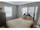 Cozy bedroom featuring large windows and a comfortable queen-size bed at 14131 Lucia Riverbend Hwy, Mount Holly, NC 28120