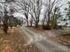 Long driveway leading to the house, surrounded by trees and foliage at 14131 Lucia Riverbend Hwy, Mount Holly, NC 28120