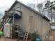 Exterior side view of a barn featuring a metal exterior, shed and access to a second level deck at 14131 Lucia Riverbend Hwy, Mount Holly, NC 28120