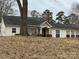 Ranch style home featuring brick chimney, covered front porch, and neutral siding at 14131 Lucia Riverbend Hwy, Mount Holly, NC 28120
