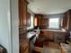 Kitchen featuring tiled countertops, wood cabinets, and wood floors at 14131 Lucia Riverbend Hwy, Mount Holly, NC 28120