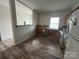 Kitchen featuring hardwood flooring, wood cabinets, stainless steel appliances, and a window at 14131 Lucia Riverbend Hwy, Mount Holly, NC 28120