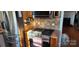 Kitchen with stainless steel appliances, tiled backsplash, and wood floors at 14131 Lucia Riverbend Hwy, Mount Holly, NC 28120