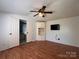 This is a bright bedroom with hard floors, ceiling fan, built-in shelving and adjacent bathroom at 143 Ezra Rd, Kings Mountain, NC 28086