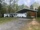 Cozy manufactured home with lush front lawn and car port at 143 Ezra Rd, Kings Mountain, NC 28086